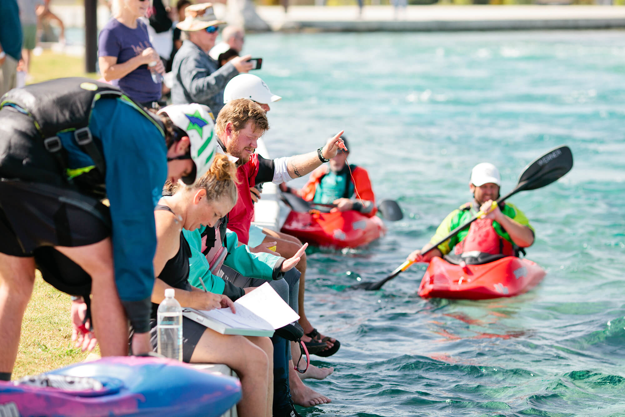 Group of kayakers and onlookers at spring events at Montgomery Whitewater Park in Montgomery, Alabama
