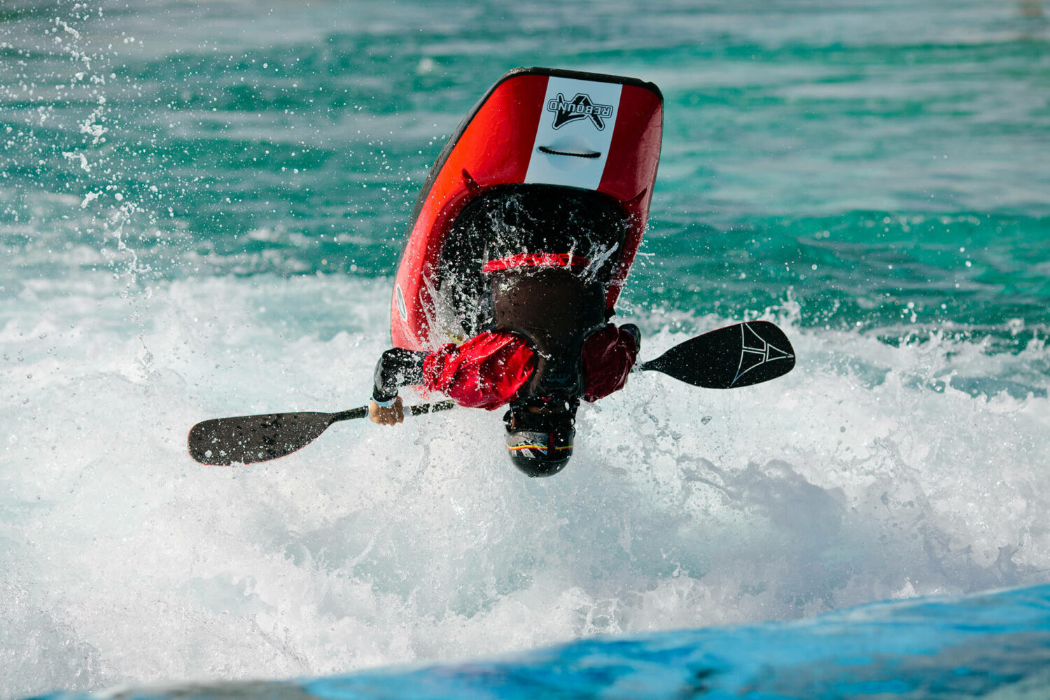 Freestyle kayaker flips at the whitewater wave at Montgomery Whitewater Park in Montgomery, Alabama.